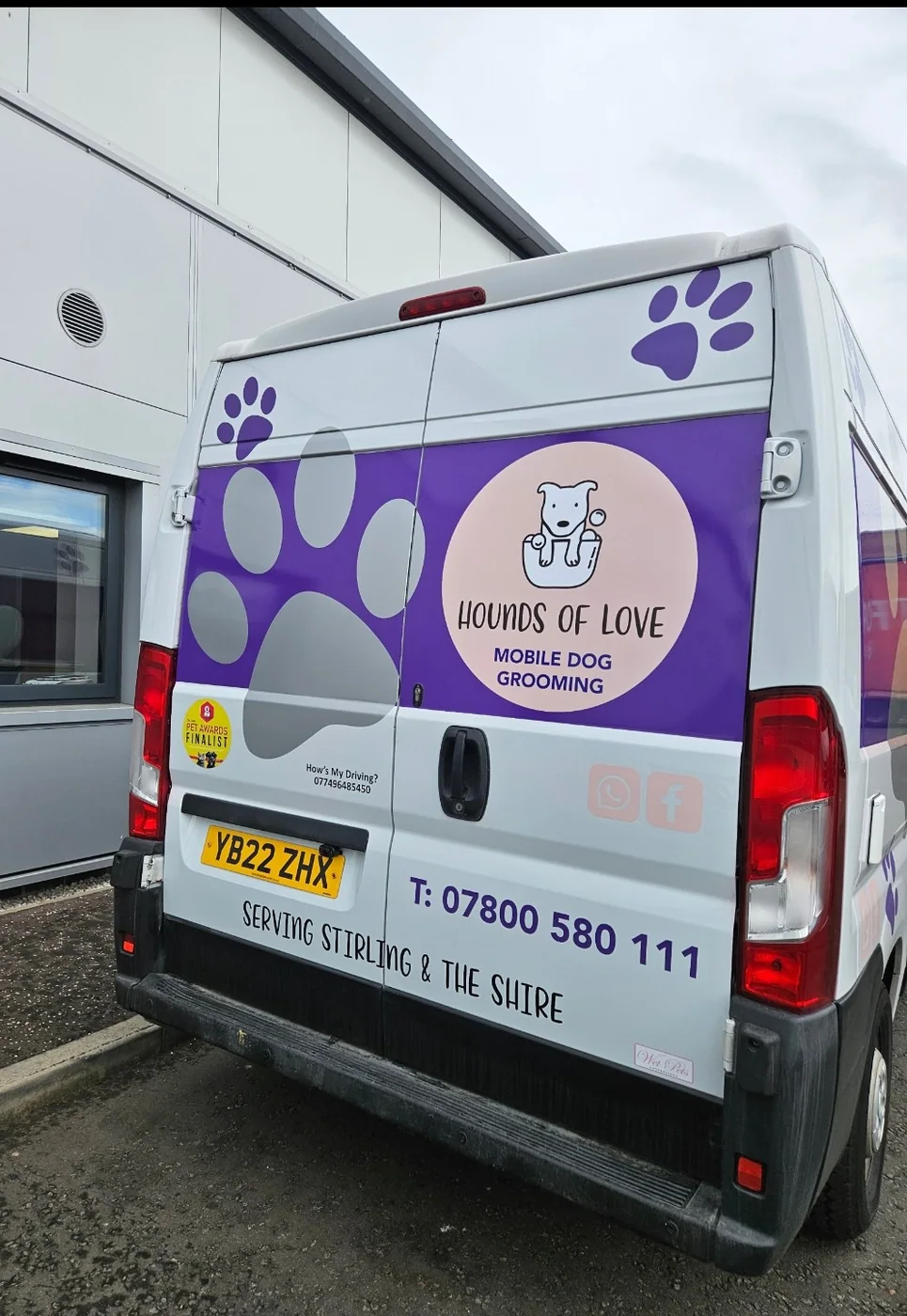 Rear of the Hounds of Love grooming van showing contact details