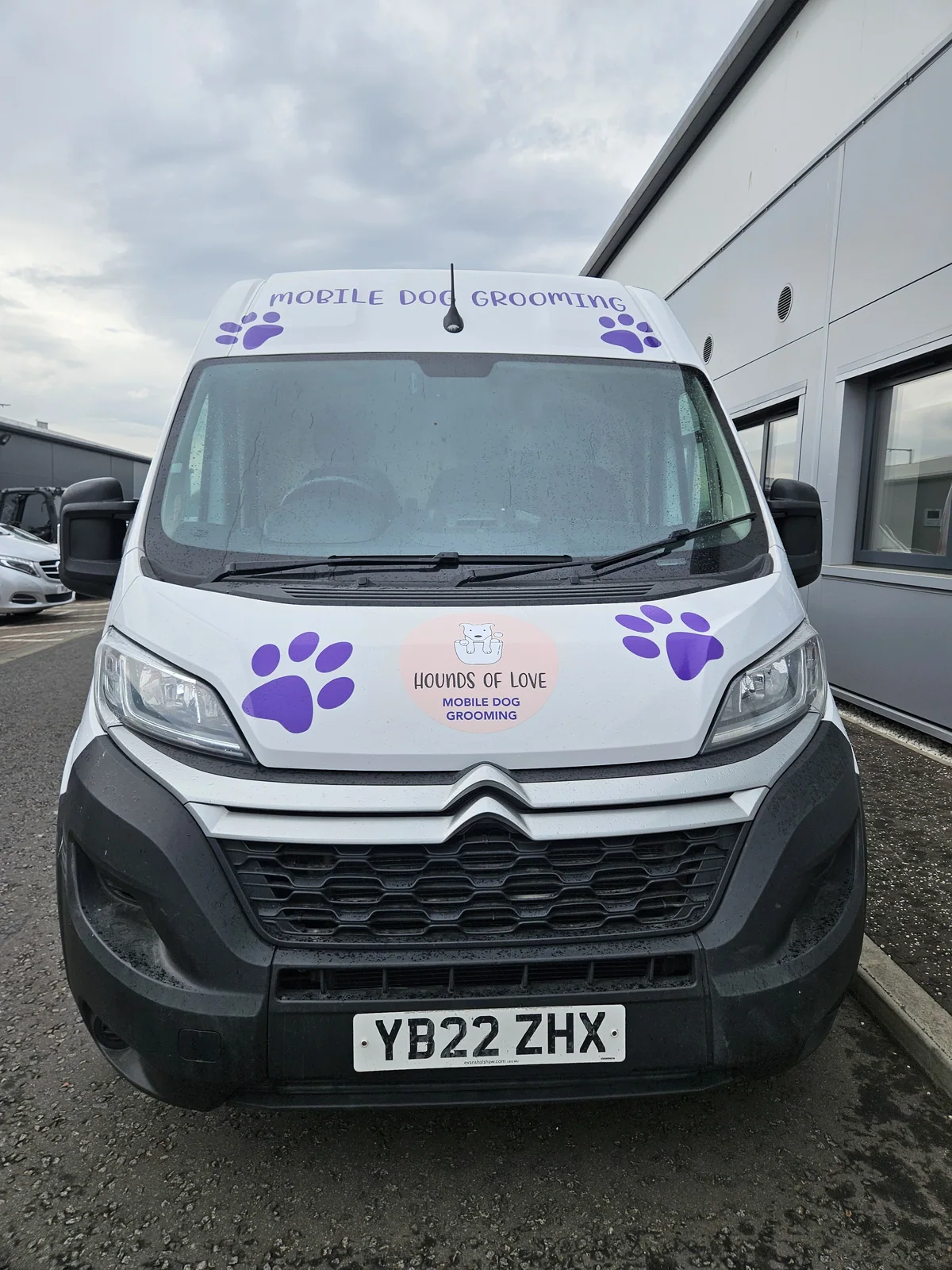 The Hounds of Love grooming van parked outside, front view